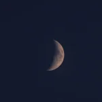 waxing crescent moon in the night sky showing lunar phase