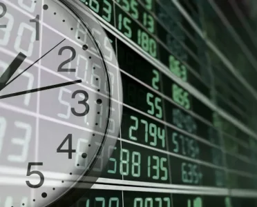 Stock market opening times worldwide with clock and financial data screen