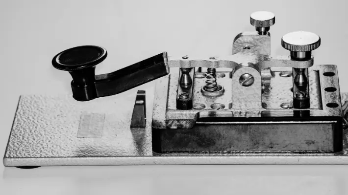 Close-up of a vintage telegraph key, the technology used to transmit the noon signal that synchronized railroad clocks across the country in 1883