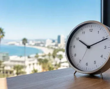 Analog clock with a Pacific Coast view representing Pacific Time
