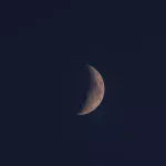 waxing crescent moon in the night sky showing lunar phase